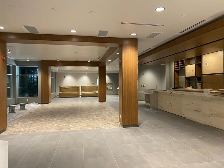 A spacious, modern interior features warm wooden accents and light flooring, ready for final furnishings.